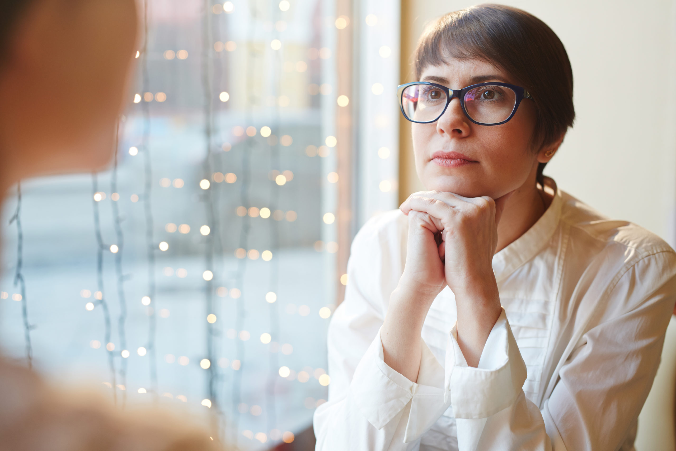 doctor listening intently to botox highlands ranch patient