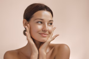 Woman with clear, healthy skin gently touching her face, representing successful acne treatment and skincare results
