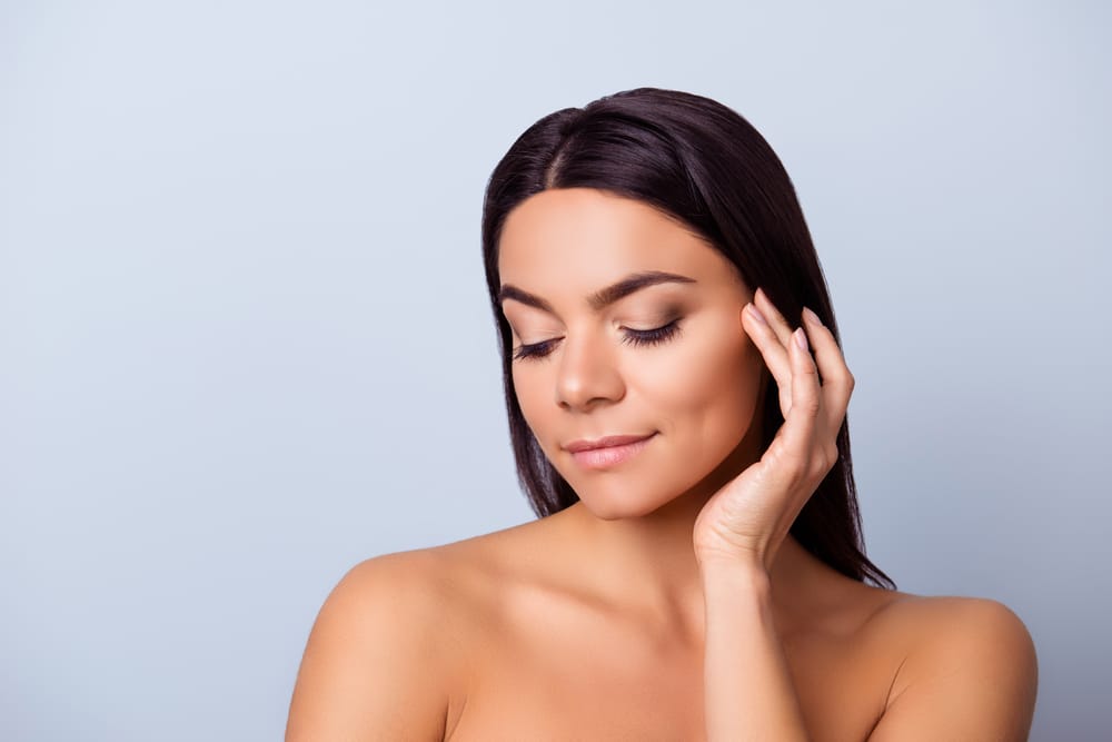 Woman with healthy, glowing skin after photofacial treatment, highlighting skin rejuvenation and bright, even complexion